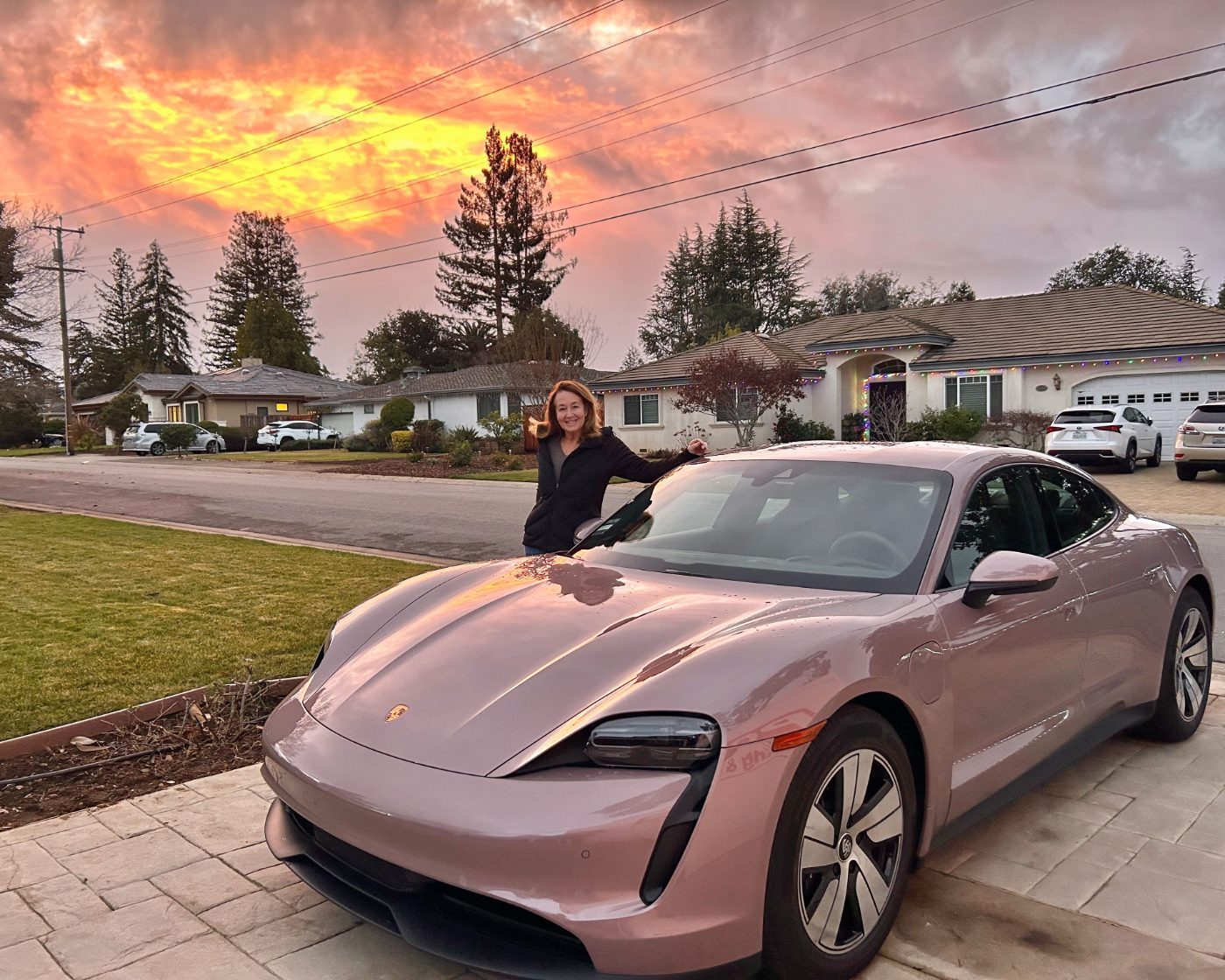 A Steer client with her new Porsche Taycan at sunset